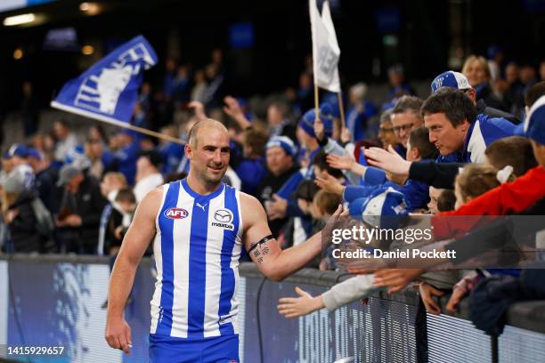 Ben Cunnington of the Kangaroos high fives fans after defeat in the round 23 AFL match between the North Melbourne Kangaroos and the Gold Coast Suns...