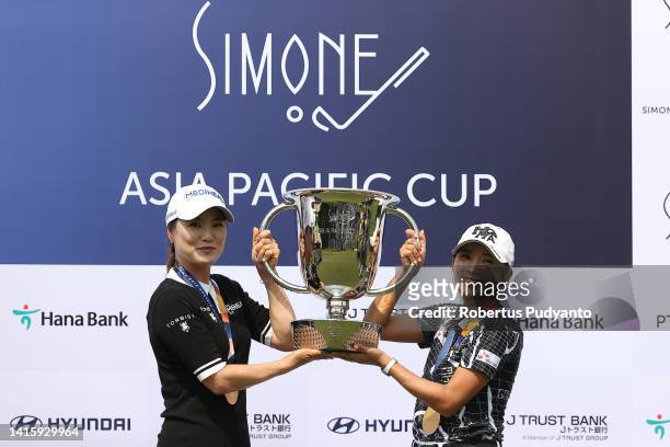 So Yeon Ryu and Bo-mee Lee of South Korea lifts the trophy at the award ceremony as they win the team competition during day three of the Simone Asia...