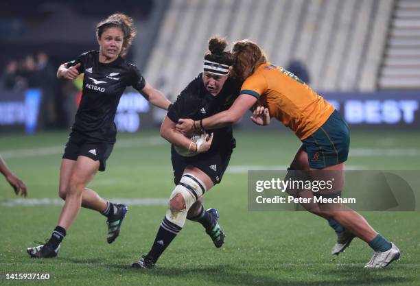 Charmaine McMenamin of New Zealand is tackled by Grace Kemp of Australia as Ruby Tui of New Zealand looms in support during the O'Reilly Cup match...