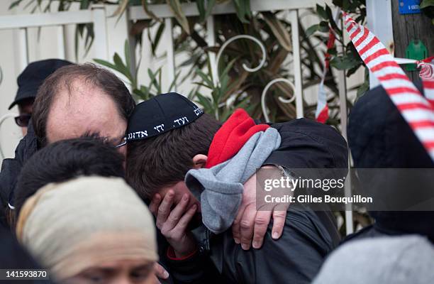 School children are comforted at the scene of a fatal shooting after a gunman opened fire outside the Ozar Hatorah school on March 19, 2012 in...