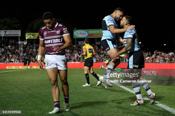 Matt Ikuvalu of the Sharks celebrates after scoring a try with Lachlan Miller of the Sharks during the round 23 NRL match between the Manly Sea...
