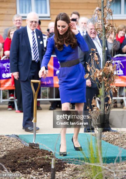 Catherine, Duchess of Cambridge plants a tree during the official opening of The Treehouse Children's Hospice on March 19, 2012 in Ipswich, England.