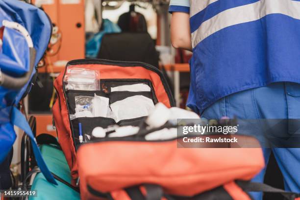 photo of an open red medical backpack in an ambulance - arzt koffer stock-fotos und bilder