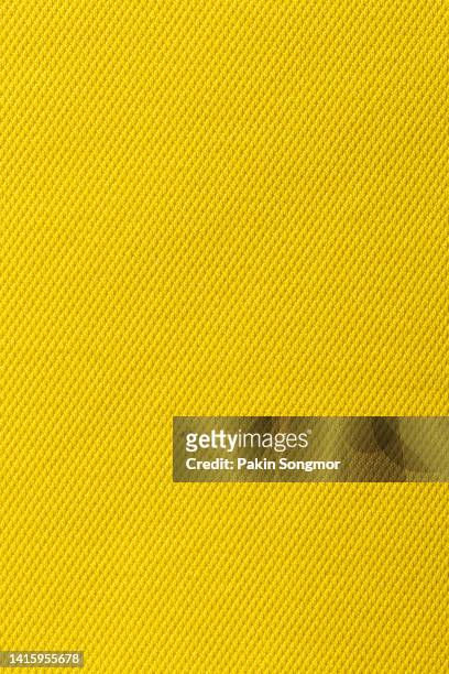 yellow color sports clothing fabric football shirt jersey texture and textile background. - jersey top stockfoto's en -beelden