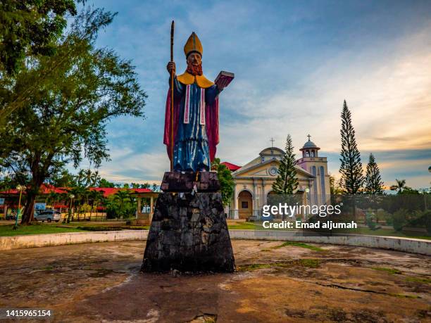 sunset view of the statue of st. augustine,  panglao, bohol, philippines - bohol philippines stock pictures, royalty-free photos & images