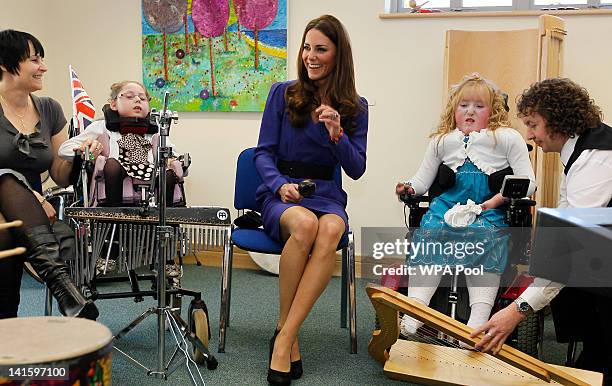 Catherine, Duchess of Cambridge joins in a music class during a visit to open The Treehouse Children's Hospice on March 19, 2012 in Ipswich, England.