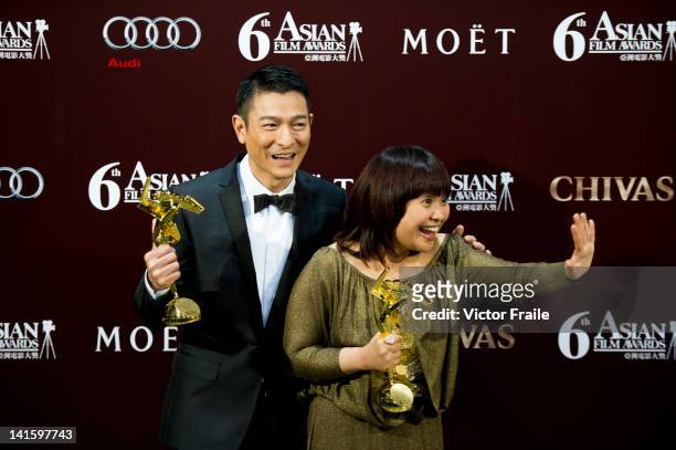 Hong Kong actor Andy Lau and Philippine actress Eugene Domingo pose with their trophies after winning the most popular actor and actress awards...