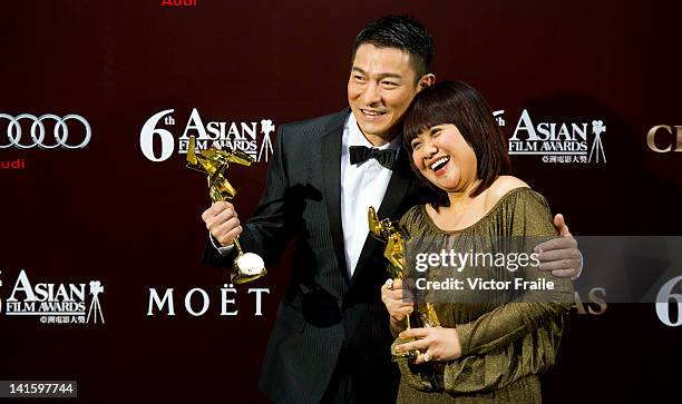 Hong Kong actor Andy Lau and Philippine actress Eugene Domingo pose with their trophies after winning the most popular actor and actress awards...