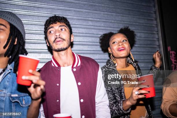 friends partying in the street at night - camera flash stock pictures, royalty-free photos & images