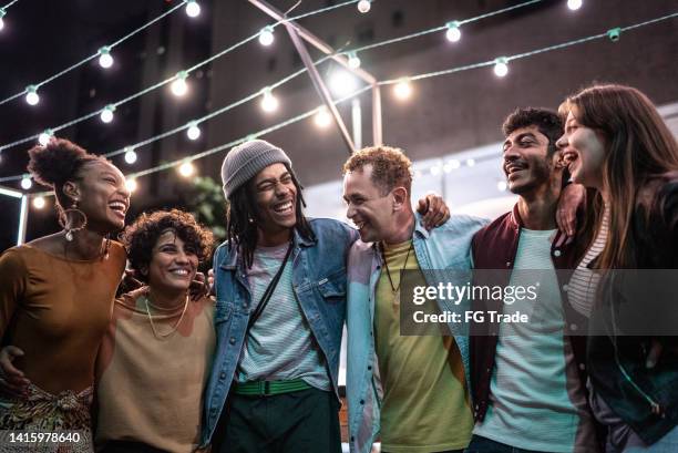 freunde, die nachts spaß auf der straße haben - straßenfest stock-fotos und bilder