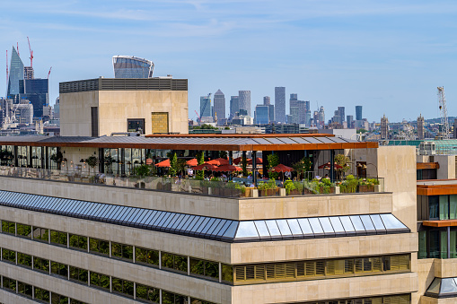 Rooftop restaurant with modern skyscrapers of Canary Wharf in the distance