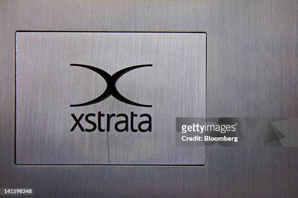 The logo of Xstrata Plc is displayed outside the building that houses the company's headquarters in Zug, Switzerland, on Monday, March 19, 2012....