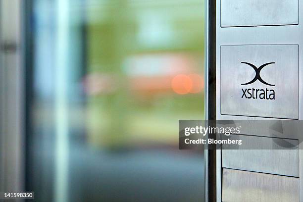 The logo of Xstrata Plc is displayed outside the building that houses the company's headquarters in Zug, Switzerland, on Monday, March 19, 2012....