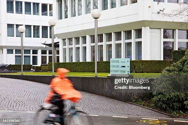 Cyclist passes the headquarters of Glencore International Plc in Baar, Switzerland, on Monday, March 19, 2012. Glencore International Plc Chief...