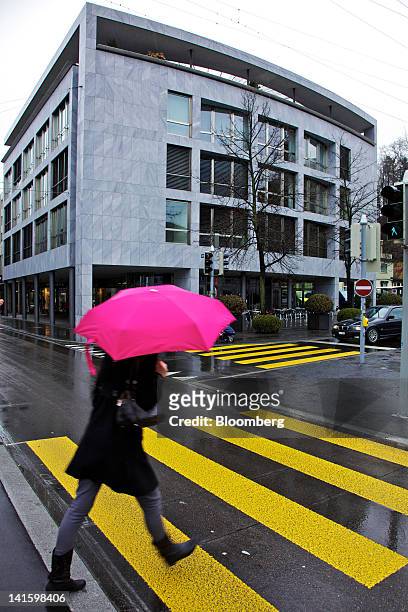 Pedestrian passes the building that houses the headquarters of Xstrata Plc in Zug, Switzerland, on Monday, March 19, 2012. Glencore International Plc...