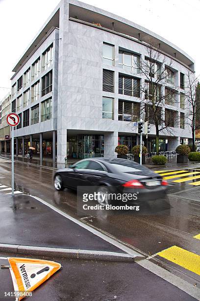 An automobile passes the building that houses the headquarters of Xstrata Plc in Zug, Switzerland, on Monday, March 19, 2012. Glencore International...