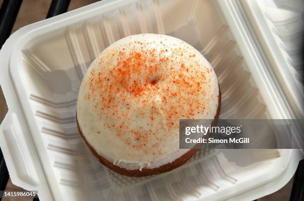 iced berliner doughnut with mamey sprinkles and mamey cream filling in a biodegradable take out box - chupachupa foto e immagini stock