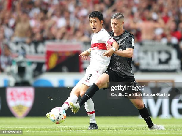 Roland Sallai of SC Freiburg battles for possession with Wataru Endo of VfB Stuttgart during the Bundesliga match between VfB Stuttgart and...