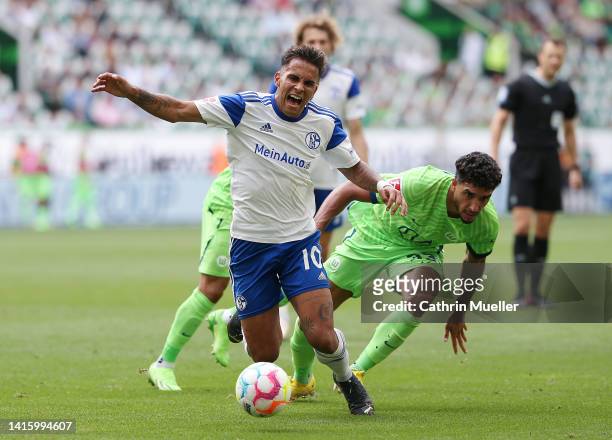 Rodrigo Zalazar of FC Schalke 04 battles for possession with Omar Marmoush of VfL Wolfsburg during the Bundesliga match between VfL Wolfsburg and FC...