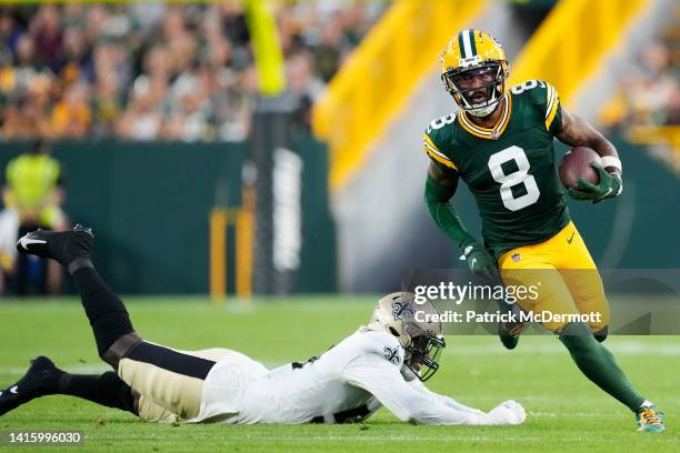 Amari Rodgers of the Green Bay Packers avoids the tackle of Taco Charlton of the New Orleans Saints in the first quarter during a preseason game at...