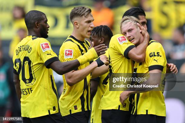 Julian Brandt of Borussia Dortmund celebrates with teammates after scoring their team's first goal during the Bundesliga match between Borussia...