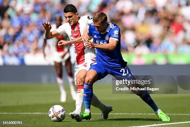 Timothy Castagne of Leicester City battles for possession with Mohamed Elyounoussi of Southampton during the Premier League match between Leicester...