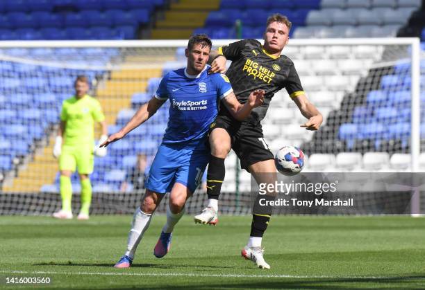 Lukas Jutkiewicz of Birmingham City is challenged by Jason Kerr of Wigan Athletic during the Sky Bet Championship match between Birmingham City and...