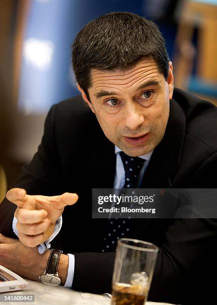 Vitor Gaspar, Portugal's finance minister, talks with an attendee before speaking at the Peterson Institute in Washington, D.C., U.S., on Monday,...