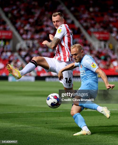 Alex Pritchard of Sunderland clears from Ben Wilmot of Stoke City during the Sky Bet Championship between Stoke City and Sunderland at Bet365 Stadium...