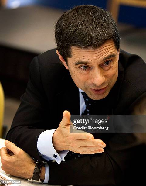 Vitor Gaspar, Portugal's finance minister, talks with an attendee before speaking at the Peterson Institute in Washington, D.C., U.S., on Monday,...