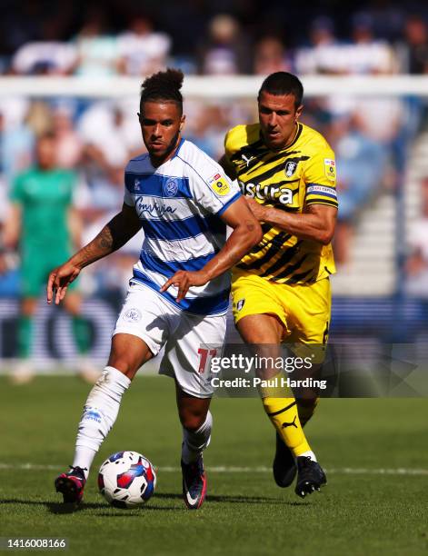 Tyler Roberts of Queens Park Rangers and Richard Wood of Rotherham United battle for the ball during the Sky Bet Championship match between Queens...