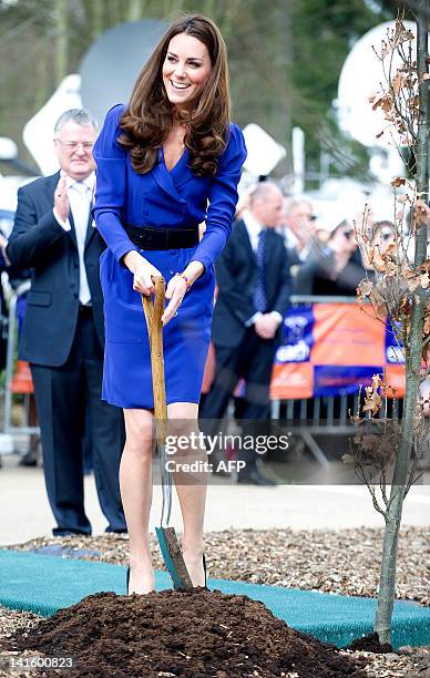 Britain's Catherine, Duchess of Cambridge plants a tree during a visit to The Treehouse in Ipswich, eastern England, on March 19, 2012. The Duchess...