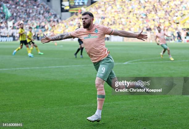 Oliver Burke of SV Werder Bremen celebrates after scoring their team's third goal during the Bundesliga match between Borussia Dortmund and SV Werder...