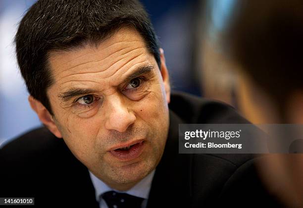 Vitor Gaspar, Portugal's finance minister, talks with an attendee before speaking at the Peterson Institute in Washington, D.C., U.S., on Monday,...