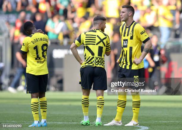 Youssoufa Moukoko, Salih Ozcan and Niklas Sule of Borussia Dortmund look dejected following their side's defeat of the Bundesliga match between...