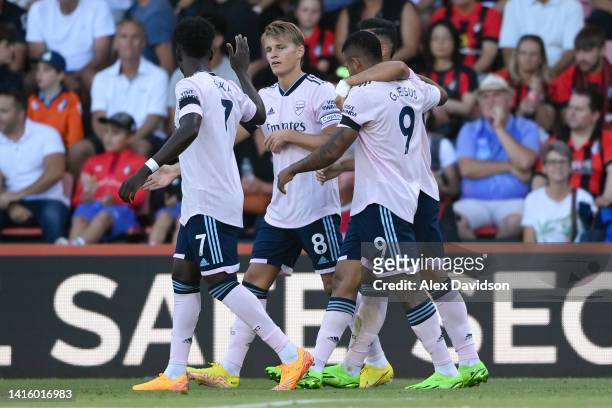Martin Odegaard of Arsenal celebrates their sides first goal with team mate Bukayo Saka during the Premier League match between AFC Bournemouth and...