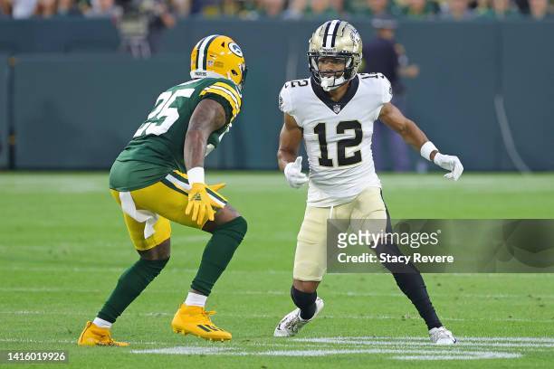 Chris Olave of the New Orleans Saints works against Keisean Nixon of the Green Bay Packers during a preseason game at Lambeau Field on August 19,...