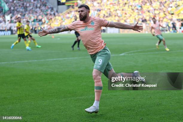 Oliver Jasen Burke of Bremen celebrates the third goal during the Bundesliga match between Borussia Dortmund and SV Werder Bremen at Signal Iduna...