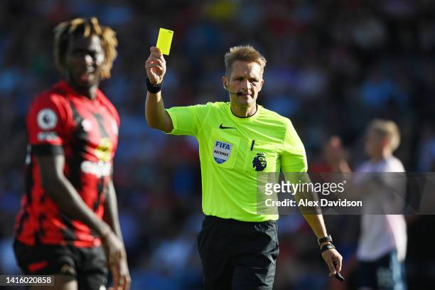 Jordan Zemura of AFC Bournemouth is shown a yellow card by Match Referee Craig Pawson during the Premier League match between AFC Bournemouth and...