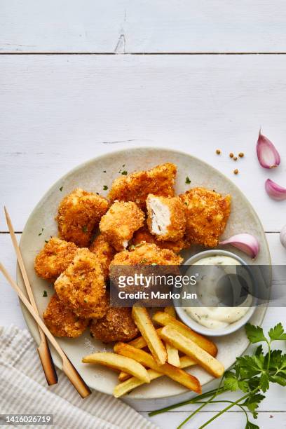 tasty chicken nuggets on a plate, with french fries and white sauce - portion control stock pictures, royalty-free photos & images
