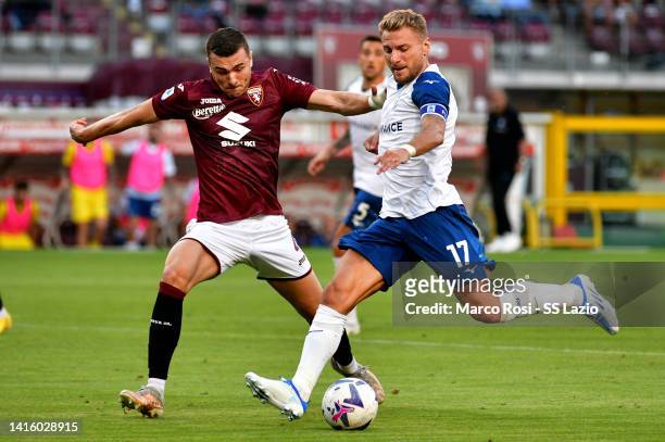 Ciro Immobile of SS Lazio compete for the ball with Alessandro Buongiornoduring the Serie A match between Torino FC and SS Lazio at Stadio Olimpico...