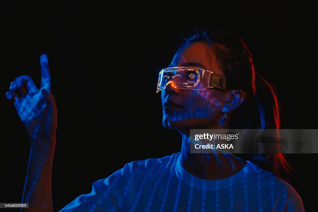 Metaverse VR virtual reality game playing, woman play metaverse virtual digital technology game control with VR goggle