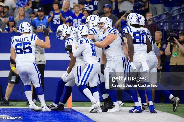 Mike Strachan of the Indianapolis Colts celebrates with his team after scoring a touchdown during the second quarter in the game against the Detroit...