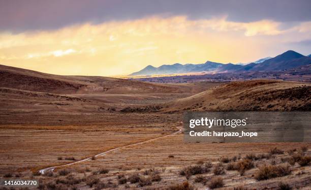 winding trail through a desert valley. - utah mountain range stock pictures, royalty-free photos & images