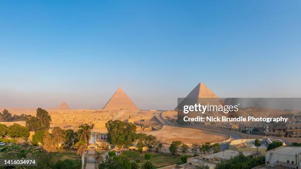 sunrise, the pyramids of giza, egypt. - cheopspyramide stock-fotos und bilder