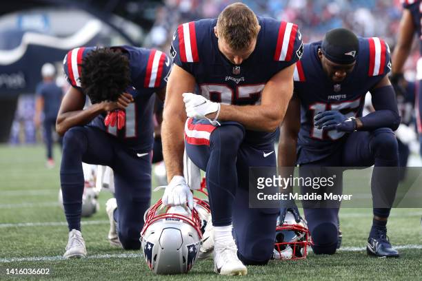 Tyquan Thornton, Matt Sokol and Nelson Agholor of the New England Patriots pray before the preseason game between the New England Patriots and the...