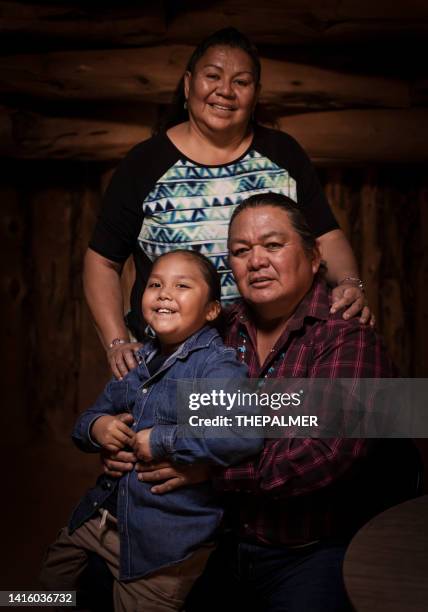 navajo family of three portrait on a traditional hogan - native african ethnicity stock pictures, royalty-free photos & images