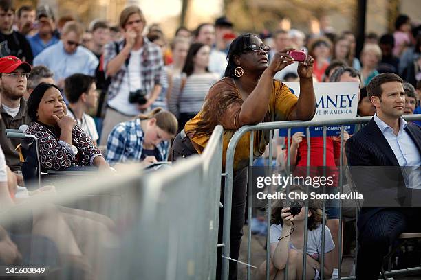 People take photographs as Rep. Aaron Schock listens to Republican presidential candidate, former Massachusetts Gov. Mitt Romney during a town-hall...
