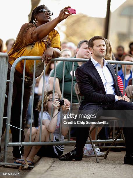 People take photographs as Rep. Aaron Schock listens to Republican presidential candidate, former Massachusetts Gov. Mitt Romney during a town-hall...