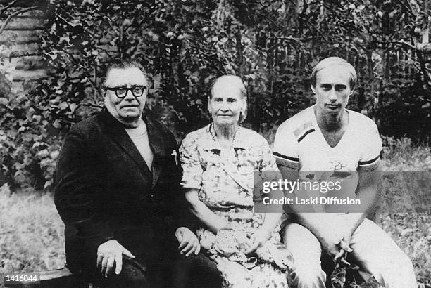 Russian President Vladimir Putin, right, poses for a photograph in this file photo with his parents Maria and Vladimir Putin in1985 just before his...